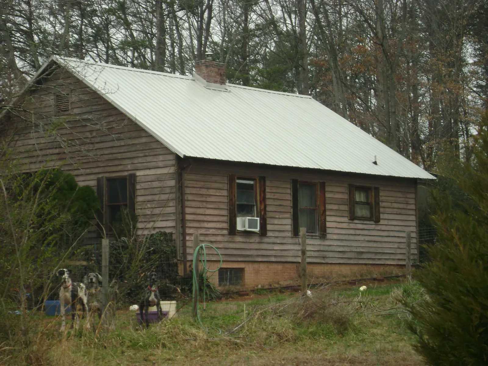 White metal roof on an old wood sided farmhouse, from a Metal Roof Installation job in Winslow